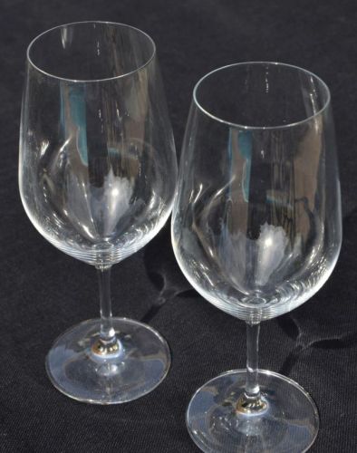 Schott Zwiesel crystal wine glasses against a black background.