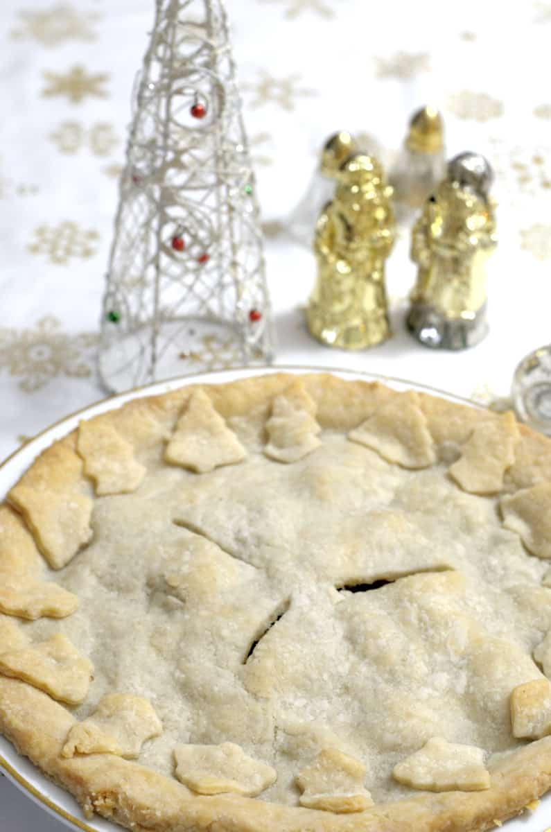 Golden baked tourtiere with Christmas Tree dough decorations.