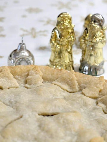 Golden baked tourtiere with Christmas Tree dough decorations.