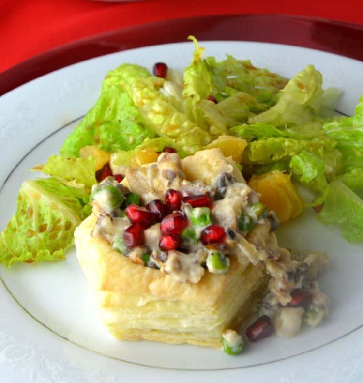 Crispy puff pastry vol au vent shell with creamy leftover turkey filling garnished with pomegranate seeds.