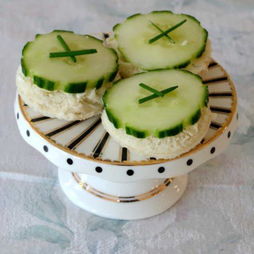 Open Faced Cucumber Tea Sandwiches on a pedastal plate.