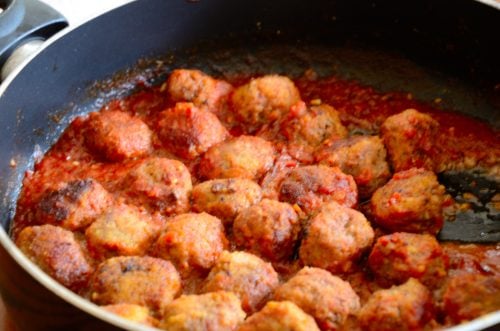 Sherry Meatballs in a frying pan with tomato sauce