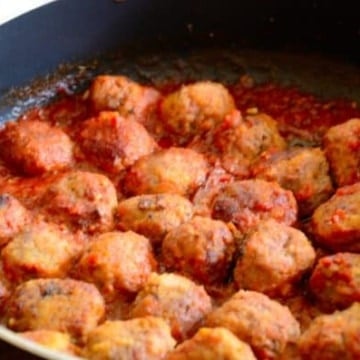 Sherry Meatballs in a frying pan with tomato sauce