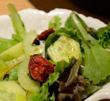 Roasted Tomato and cucumber on salad greens.
