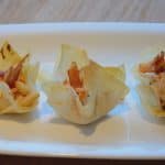 Phyllo pastry cups on a white serving dish.