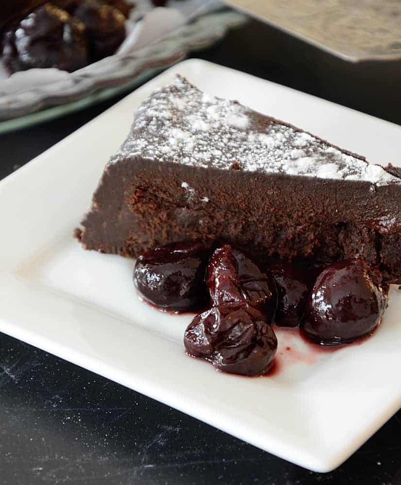 Flourless Chocolate Cake Garnished with Black Cherries