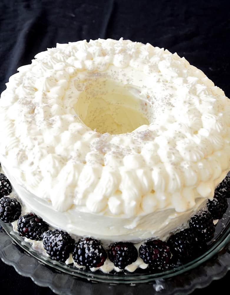 Liqueur Bundt Cake with Cream Cheese Icing on a platter.