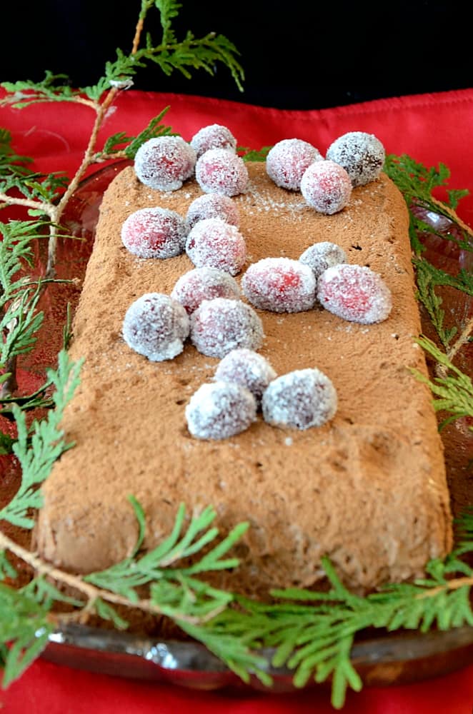 Loaf shaped chocolate semifreddo decorated with cocao powder and sugared cranberries.