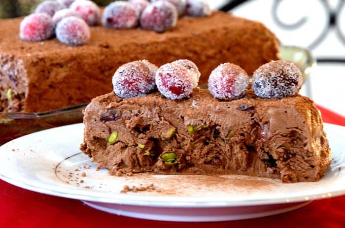 Loaf shaped chocolate semifreddo decorated with cocao powder and sugared cranberries.