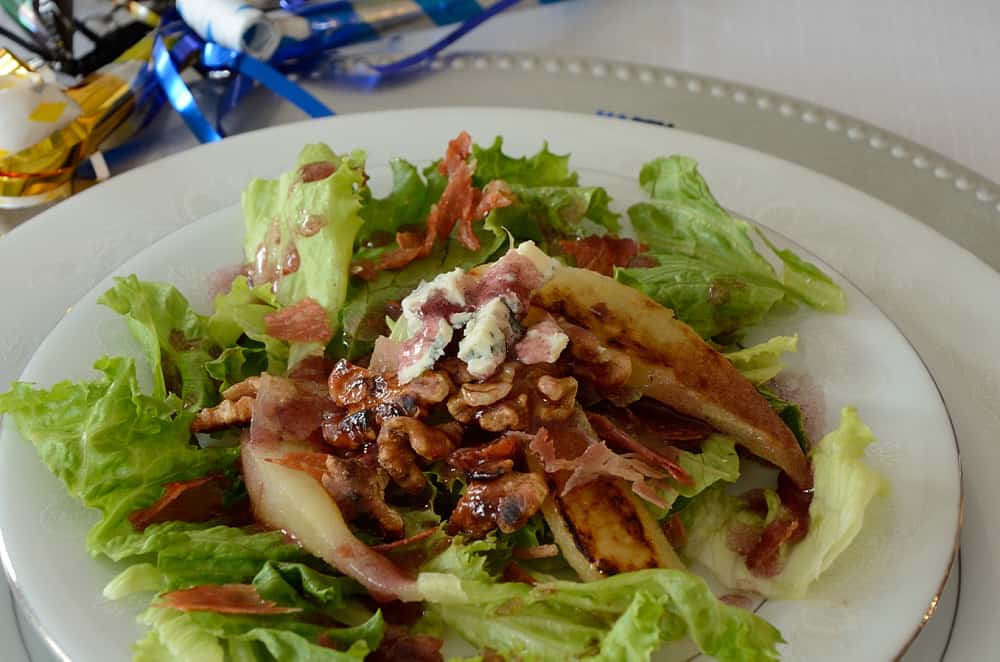 Salad with grilled pear on a plate.