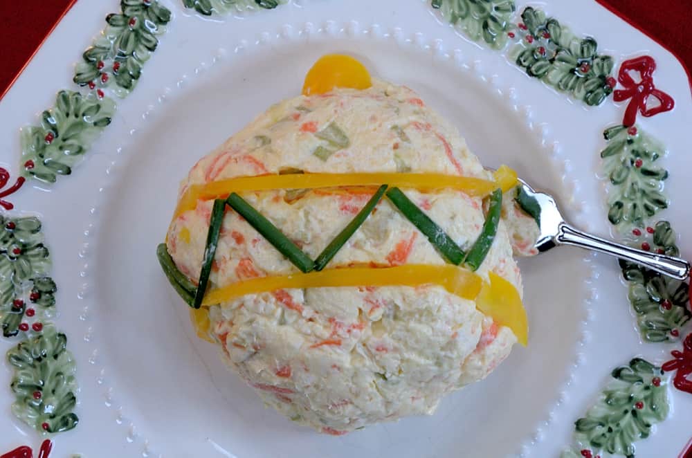 Veggie Cheese Spread shaped like a Christmas ornament on a plate.