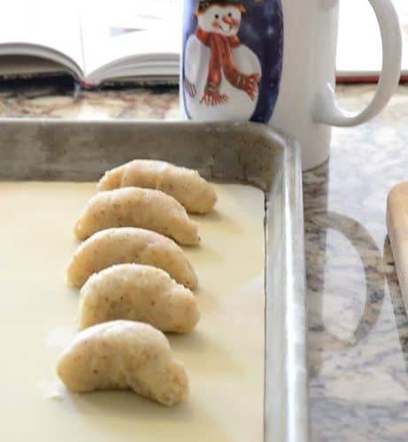 uncooked german vanilla crescents on baking sheet