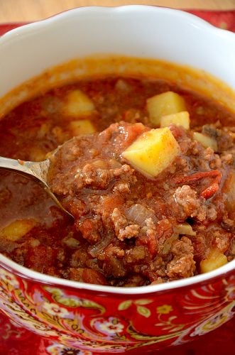 Close up of spoonful of meaty hamburger and potato soup