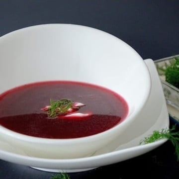 Polish Borscht soup in a bowl with sour cream and dill garnish
