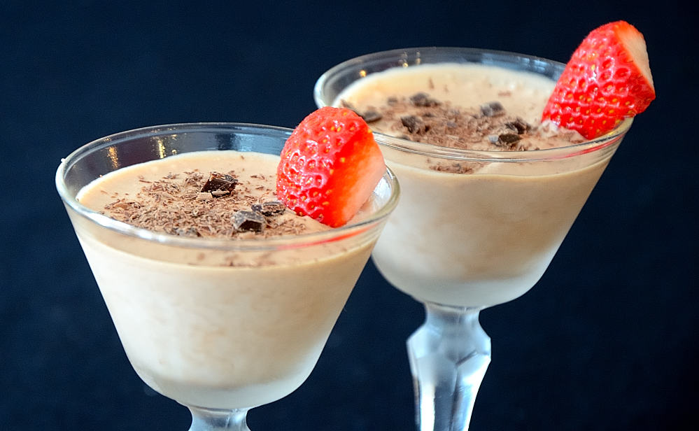 Dessert cups filled with frozen chocolate pudding garnished with strawberry