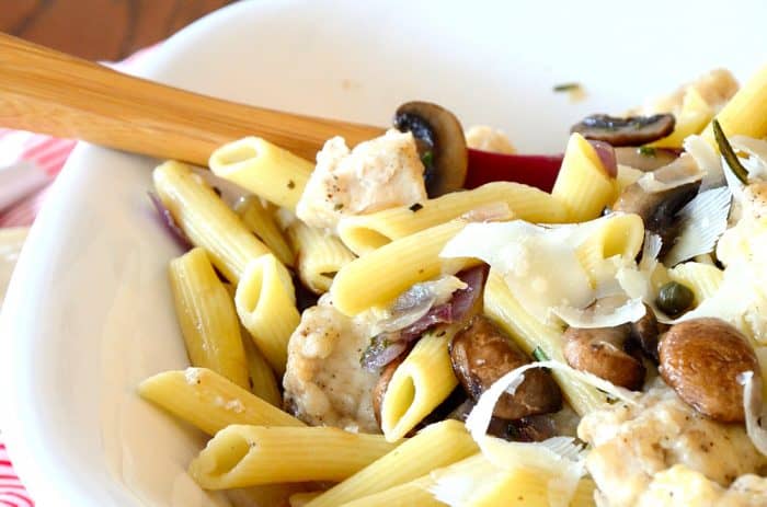 bowl of penne with mushrooms and spoon