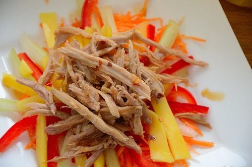 Shredded duck meat on a bed of julienned mango, carrot and celery