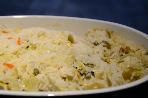 Cooked rice with artichokes and capers in a casserole.