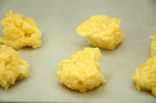 Uncooked Gougères on baking sheet