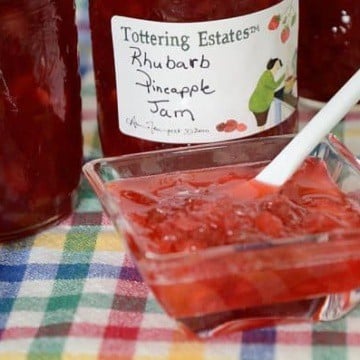 Rhubarb Pineapple Freezer Jam in a small dish with jam jars behind.