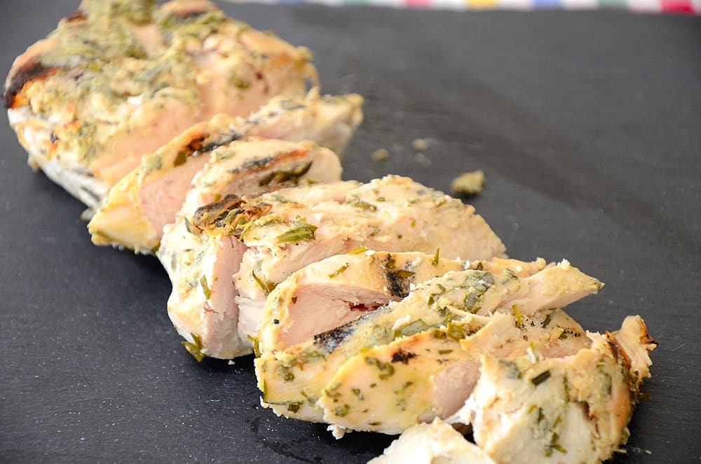 Grilled Chicken with Dijon Tarragon coating sliced on serving tray