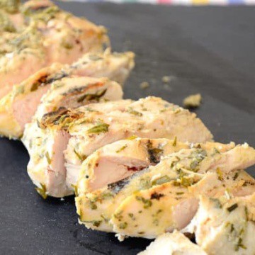Grilled Chicken with Dijon Tarragon coating sliced on serving tray