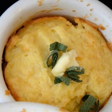 Pot of potato and cheddar souffle with sage butter topping