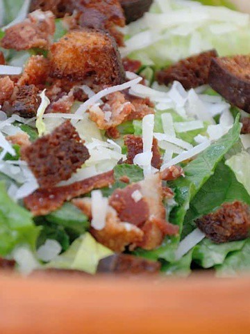 Caesar salad in a wooden bowl.