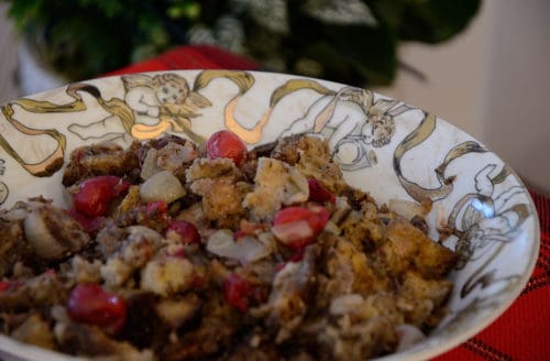 A bowl of bread stuffing with cranberries and pecans