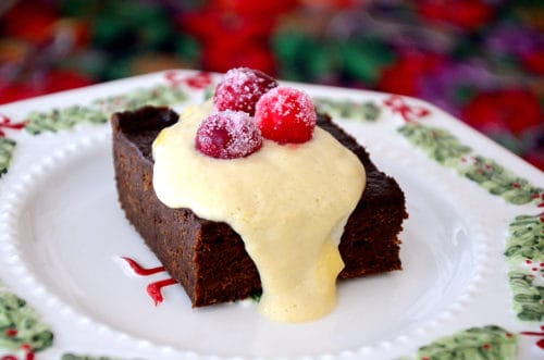 Brownie dripping with Brandy cream sauce garnished with sugared cranberries