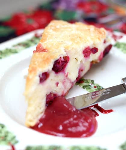 Individual scone on a plate with cranberry pear butter