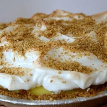 Whole pie with meringue topping and graham crumbs on top.