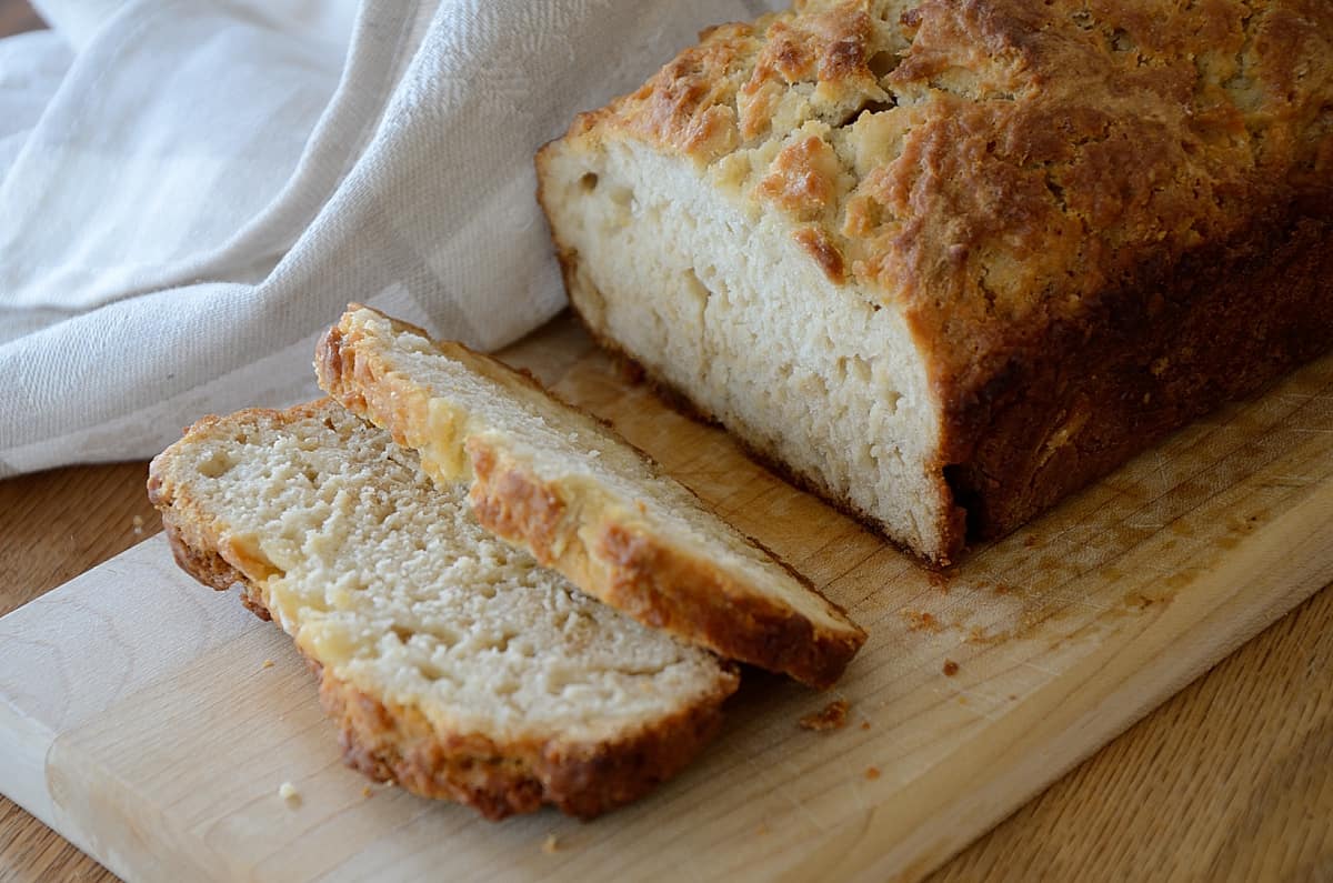 Loaf of beer bread on a cutting board.