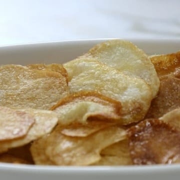 Close up of golden brown potato chips in a dish