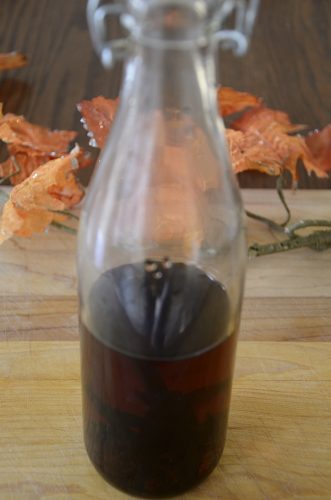 Glass bottle of dark homemade vanilla.