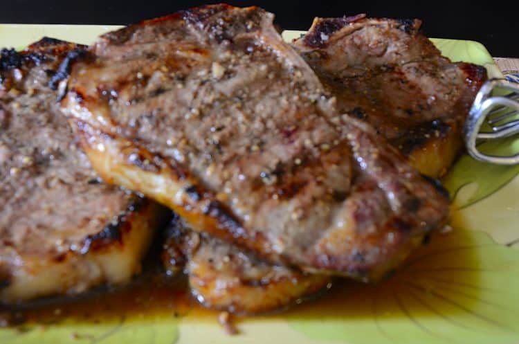Close up of grilled strip loin steack with juicy marinade caramelized on it
