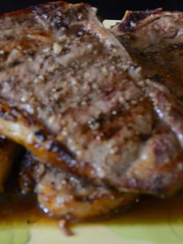 Close up of grilled strip loin steack with juicy marinade caramelized on it