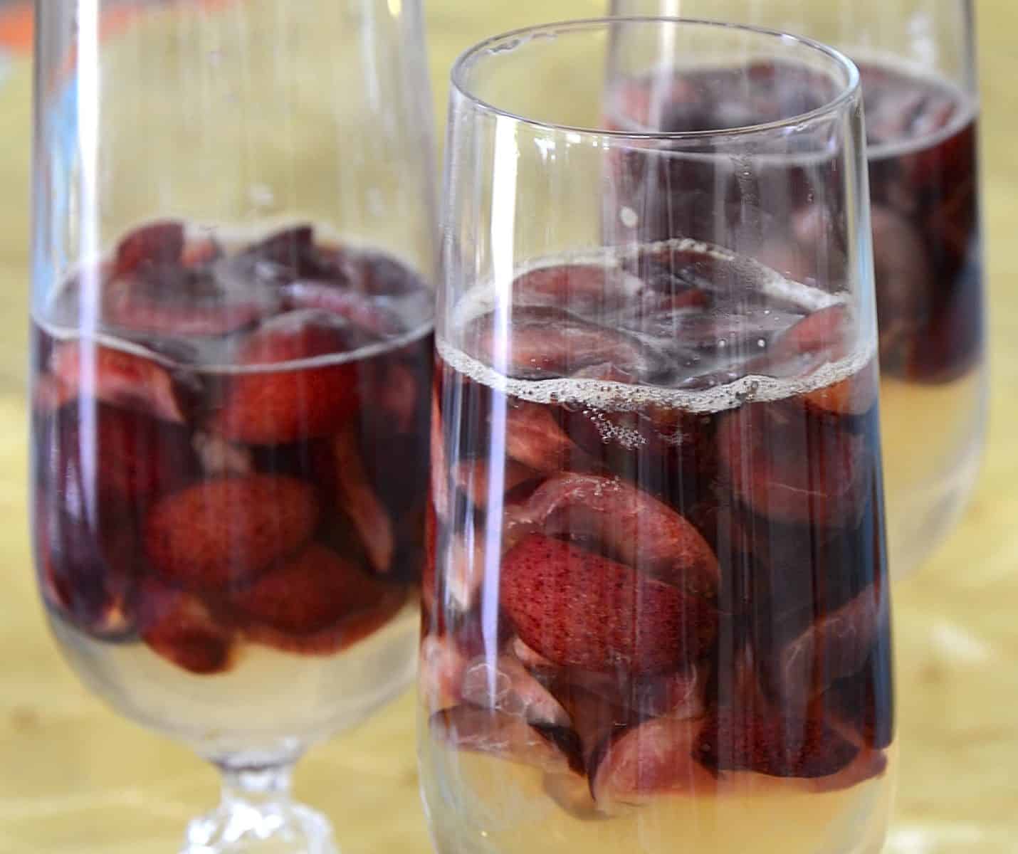 Champagne gelatin with fresh cherries in a champagne flute.