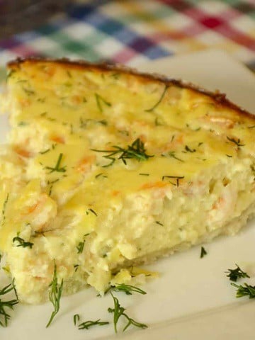 Slice of shrimp tarte with fresh dill.