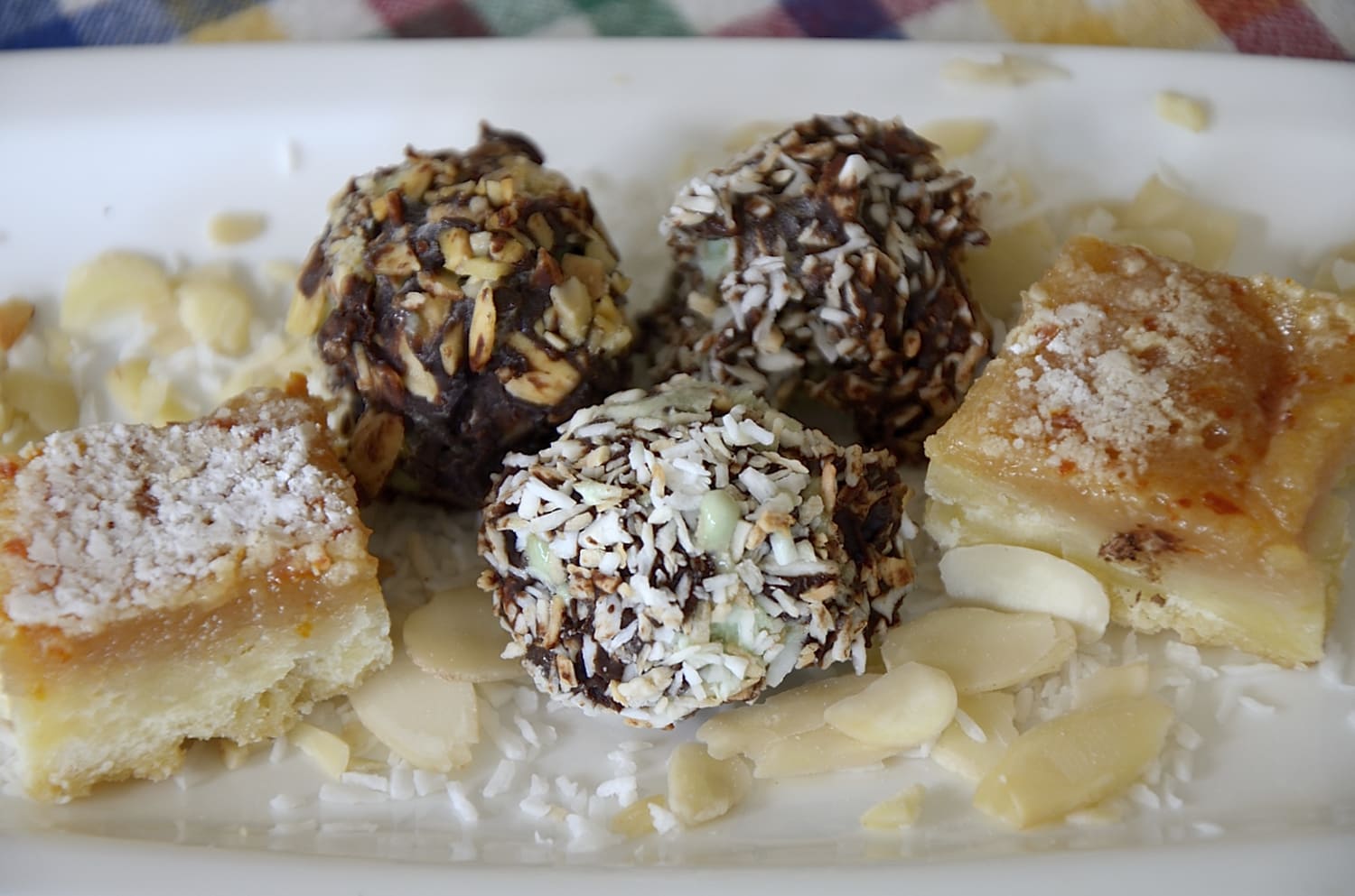 3 ice cream truffles coated in chocolate and toasted coconut and toasted almonds