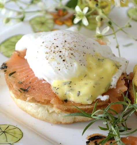 One poached egg on croissant bun with cured salmon and bearnaise sauce.