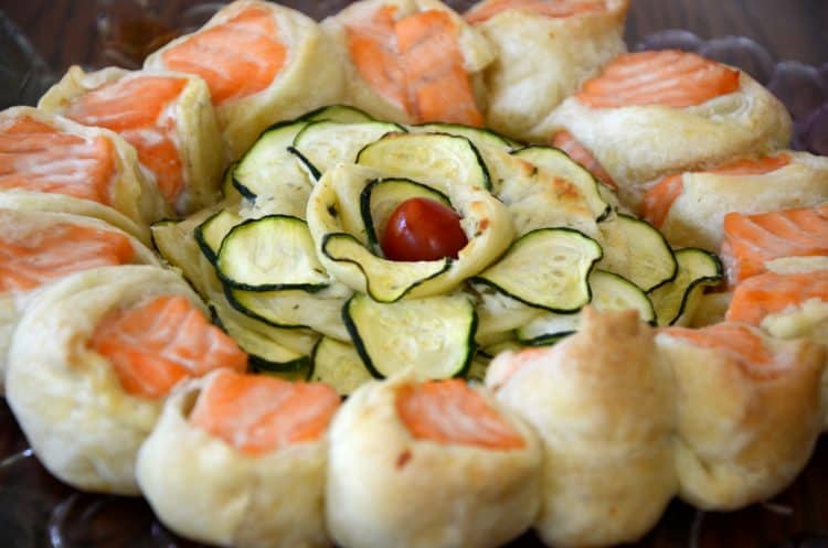 Salmon wrapped in puff pastry with a zucchini rosette in the center and baked til golden brown.