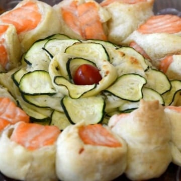 Baked Salmon Spiral in Puff pastry with zucchini rose in center.