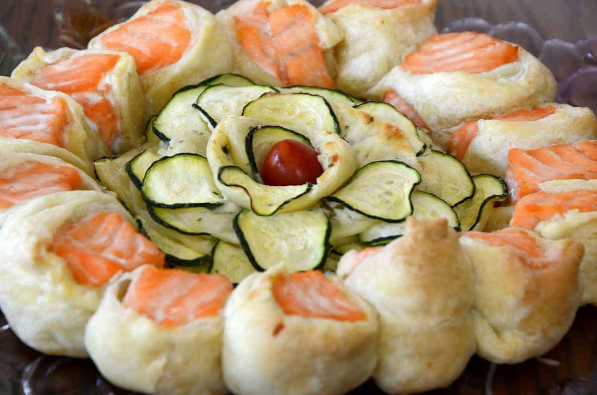 Baked Salmon Spiral in Puff pastry with zucchini rose in center.