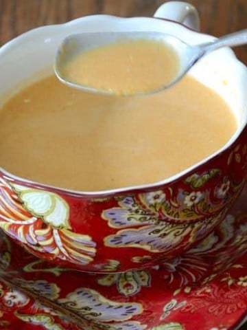 Creamy roasted red pepper soup in soup cup.