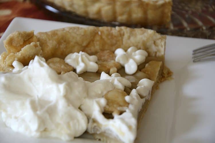 slice of Maple Cream Tarte decorated with whipped cream.