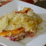 Serving of layered beets, sweet potato, Yukon Gold potatoes, cheese and panko crumb topping.