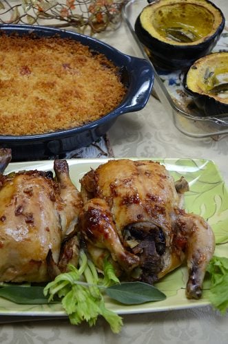 Table setting Cornish hens, stuffed with Root Vegetable casserole and baked squash.