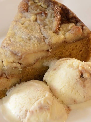 Slice of pumpkin apple streusel cake with apple cider ripple ice cream on the side.