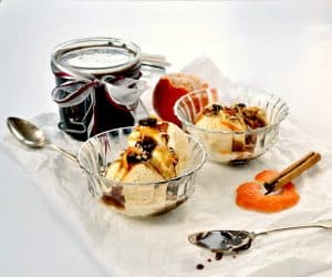Cups of ice cream topped with Christmas Pudding Toffee Sauce.